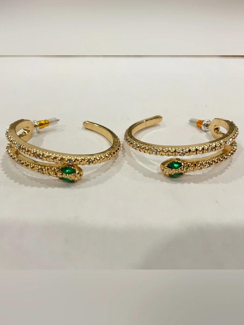 Gold Sparkle Snake Hoop Earrings with Green Eye Stone Accents